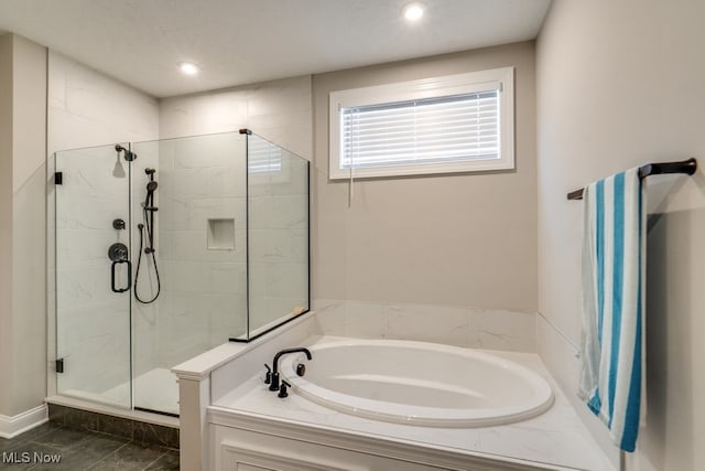 bathroom featuring a textured ceiling, shower with separate bathtub, and tile patterned floors