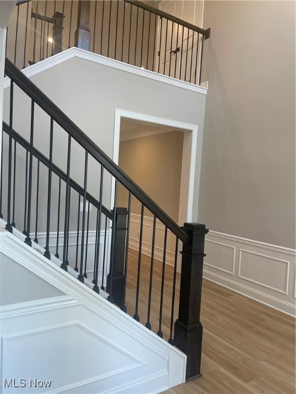 staircase with hardwood / wood-style floors