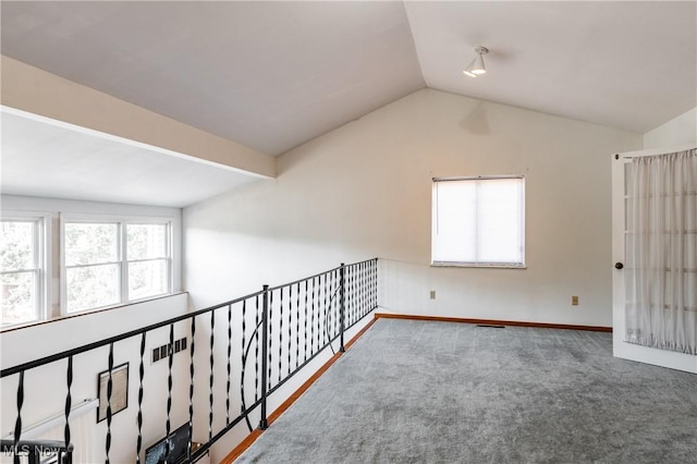 unfurnished room with lofted ceiling and carpet flooring