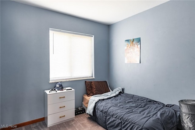 bedroom with multiple windows and carpet flooring