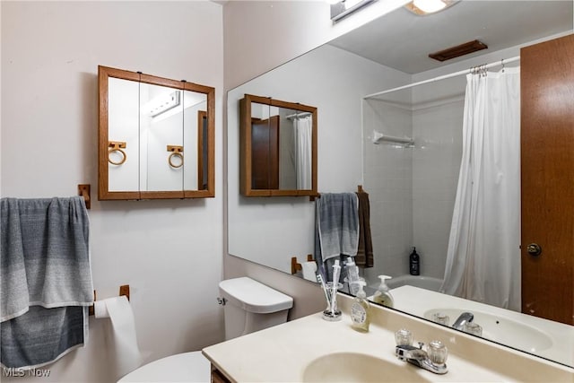 full bathroom with sink, toilet, and shower / bathtub combination with curtain