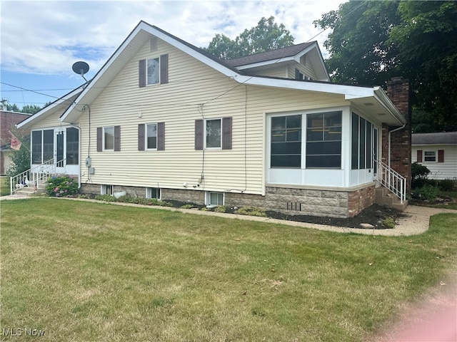 rear view of house featuring a yard