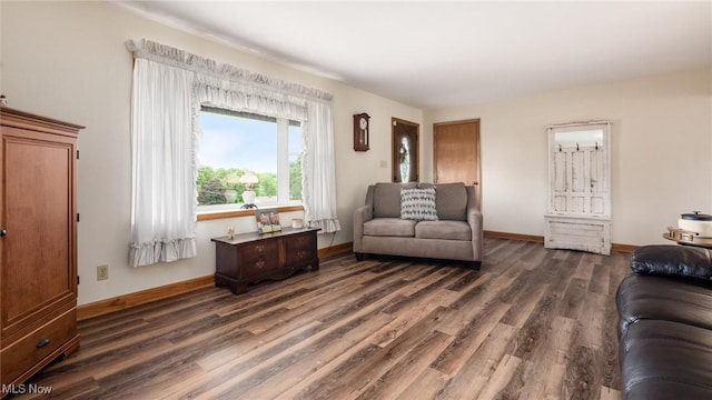 living area featuring dark wood finished floors and baseboards