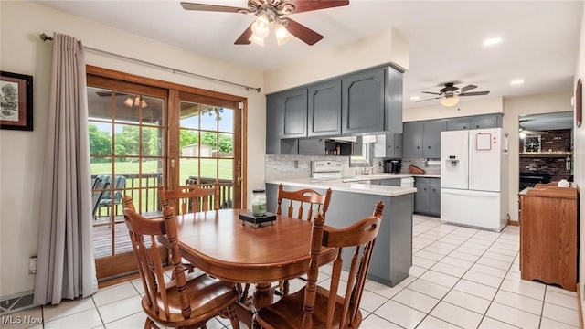 dining room featuring visible vents, ceiling fan, light tile patterned floors, recessed lighting, and a fireplace