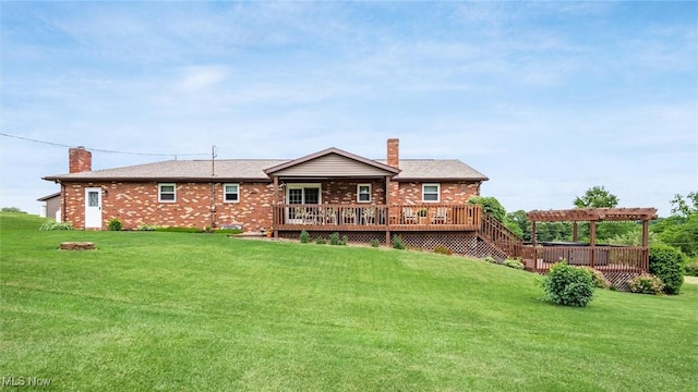 rear view of house featuring brick siding, a wooden deck, a chimney, a yard, and a pergola