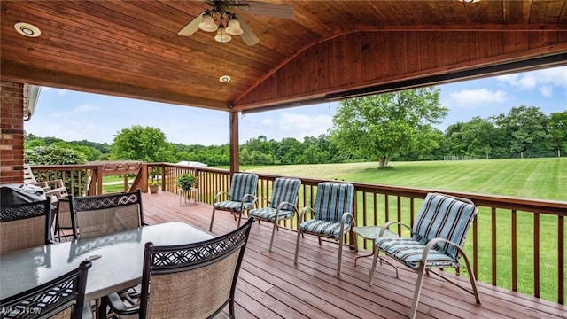 deck with a yard and a ceiling fan