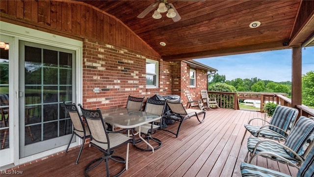 wooden terrace featuring ceiling fan and outdoor dining space