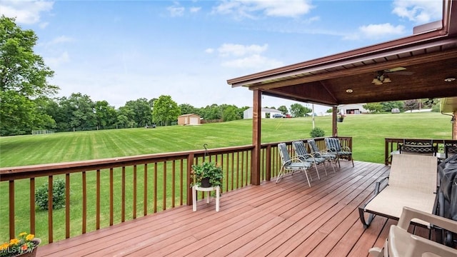 deck featuring an outbuilding and a lawn