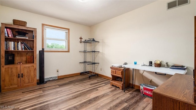 office featuring visible vents, baseboards, and light wood-style floors