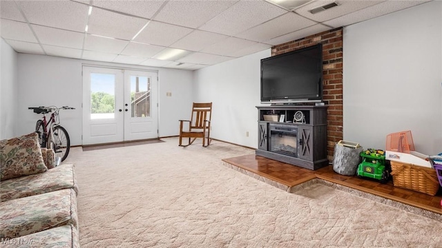 living area with visible vents, a drop ceiling, french doors, carpet flooring, and baseboards