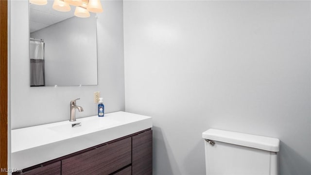 full bathroom with toilet and vanity