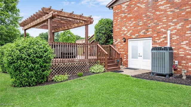 view of yard with central air condition unit, a wooden deck, and a pergola