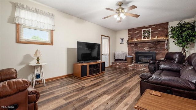 living room featuring a fireplace, wood finished floors, baseboards, and a ceiling fan