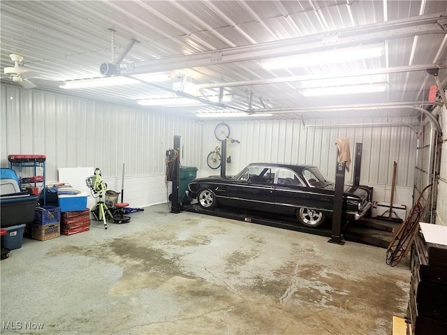 garage featuring a garage door opener and metal wall