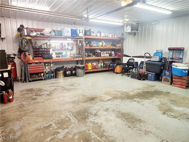 garage featuring a workshop area and metal wall