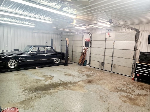 garage with a garage door opener and metal wall