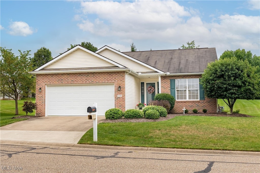 single story home featuring a front lawn and a garage