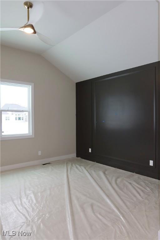 spare room featuring vaulted ceiling