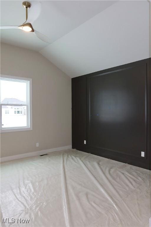 additional living space with vaulted ceiling and baseboards