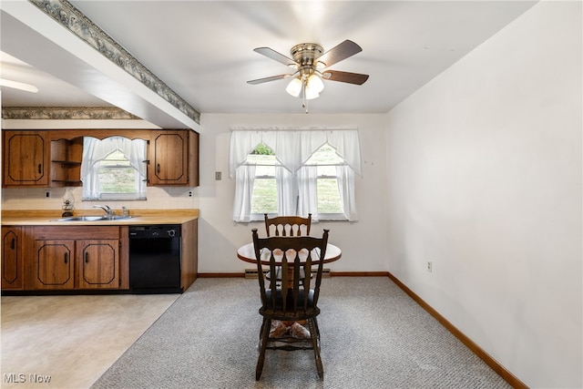 dining space with ceiling fan, a wealth of natural light, sink, and light colored carpet