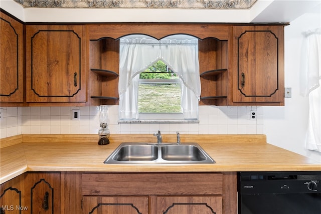 kitchen featuring backsplash, dishwasher, and sink