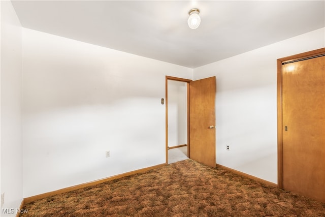 unfurnished bedroom with a closet and carpet floors