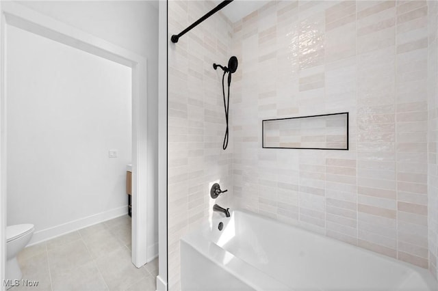 bathroom featuring shower / bathing tub combination, baseboards, toilet, and tile patterned flooring