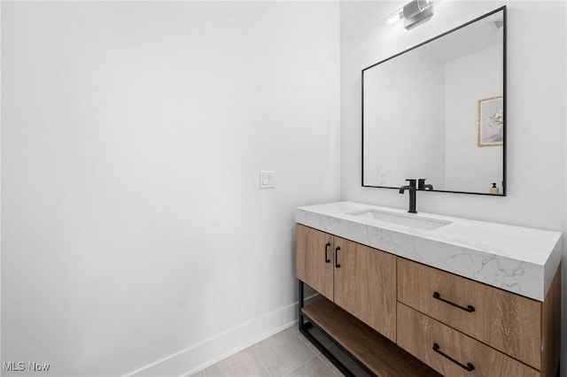 bathroom featuring tile patterned floors, baseboards, and vanity