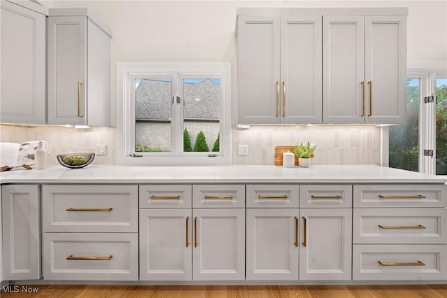 kitchen with decorative backsplash and light countertops