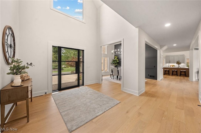 entryway with visible vents, a healthy amount of sunlight, and light wood-style flooring