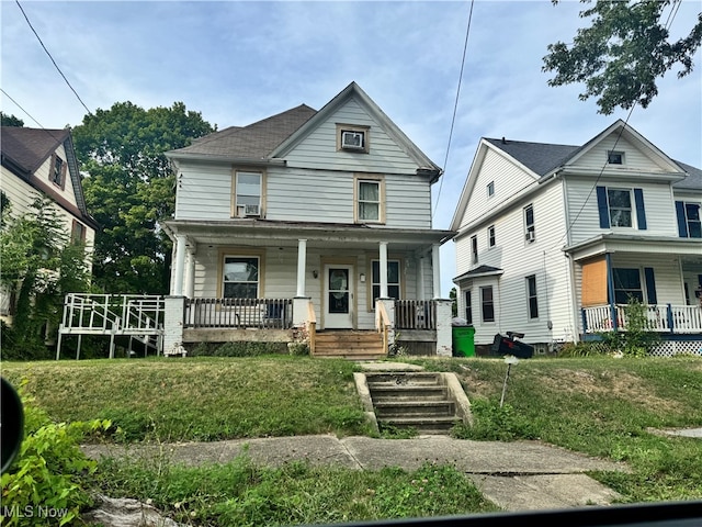 view of front of house with a porch and a front lawn