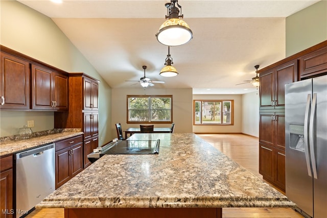 kitchen featuring stainless steel appliances, light hardwood / wood-style flooring, a kitchen island, ceiling fan, and hanging light fixtures