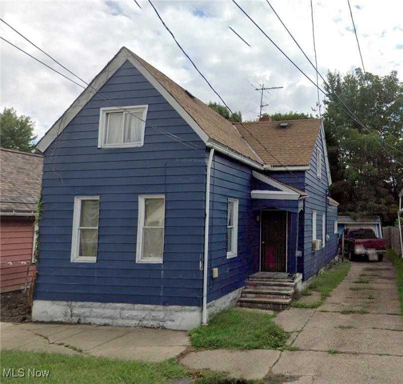 bungalow with roof with shingles and entry steps