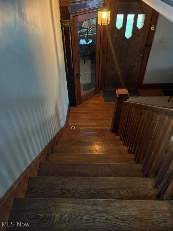 stairs featuring hardwood / wood-style flooring