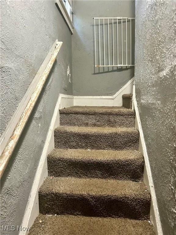 stairs with a textured wall