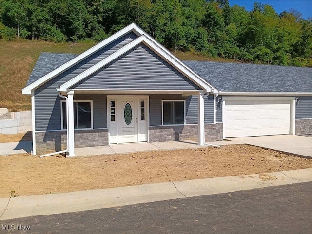 view of front of home with a garage and a porch