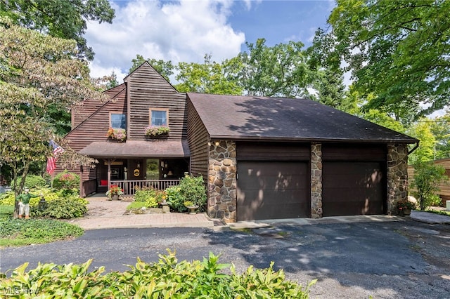 view of front of house with a porch and a garage