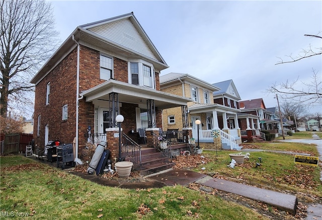 view of front facade featuring covered porch and a front lawn