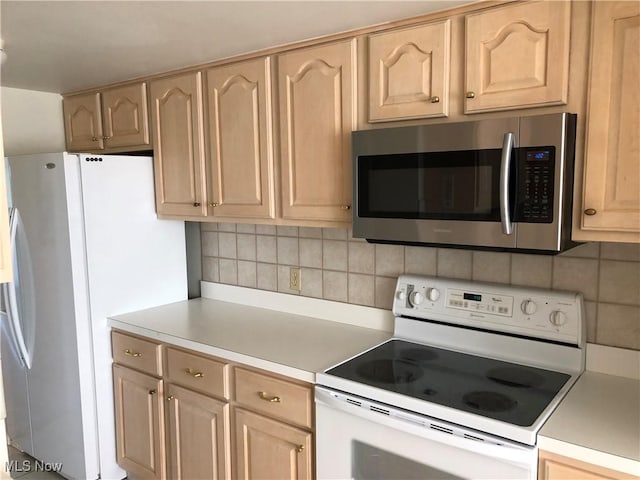 kitchen featuring light countertops, light brown cabinets, backsplash, and white appliances