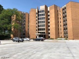view of property featuring uncovered parking
