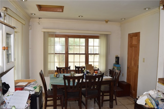 dining space featuring tile patterned floors and crown molding