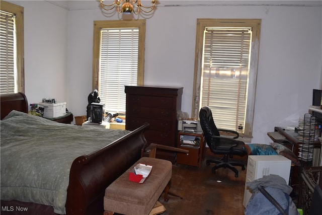 bedroom featuring a notable chandelier