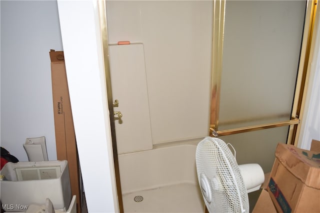 bathroom with a shower and toilet