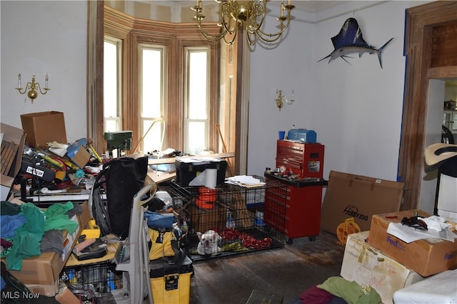 interior space with a notable chandelier, crown molding, and wood-type flooring