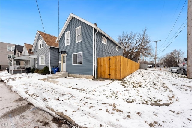 view of snow covered rear of property