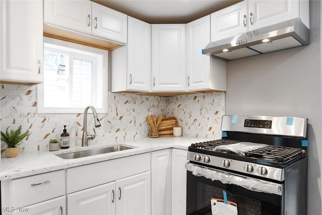 kitchen featuring stainless steel range with gas cooktop, sink, white cabinets, and light stone countertops