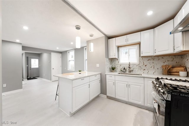 kitchen with white cabinets, pendant lighting, kitchen peninsula, and sink