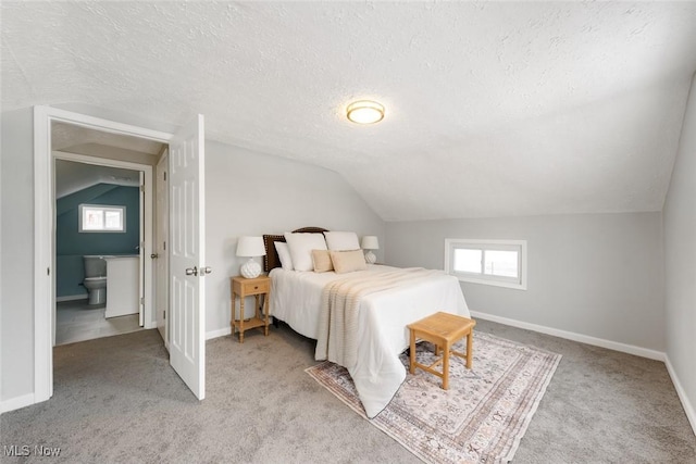 bedroom with lofted ceiling, light colored carpet, and a textured ceiling