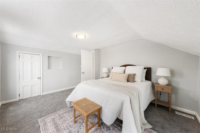 carpeted bedroom featuring a textured ceiling, vaulted ceiling, and a closet