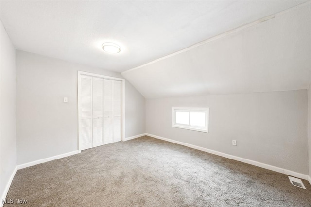 bonus room with carpet floors and vaulted ceiling